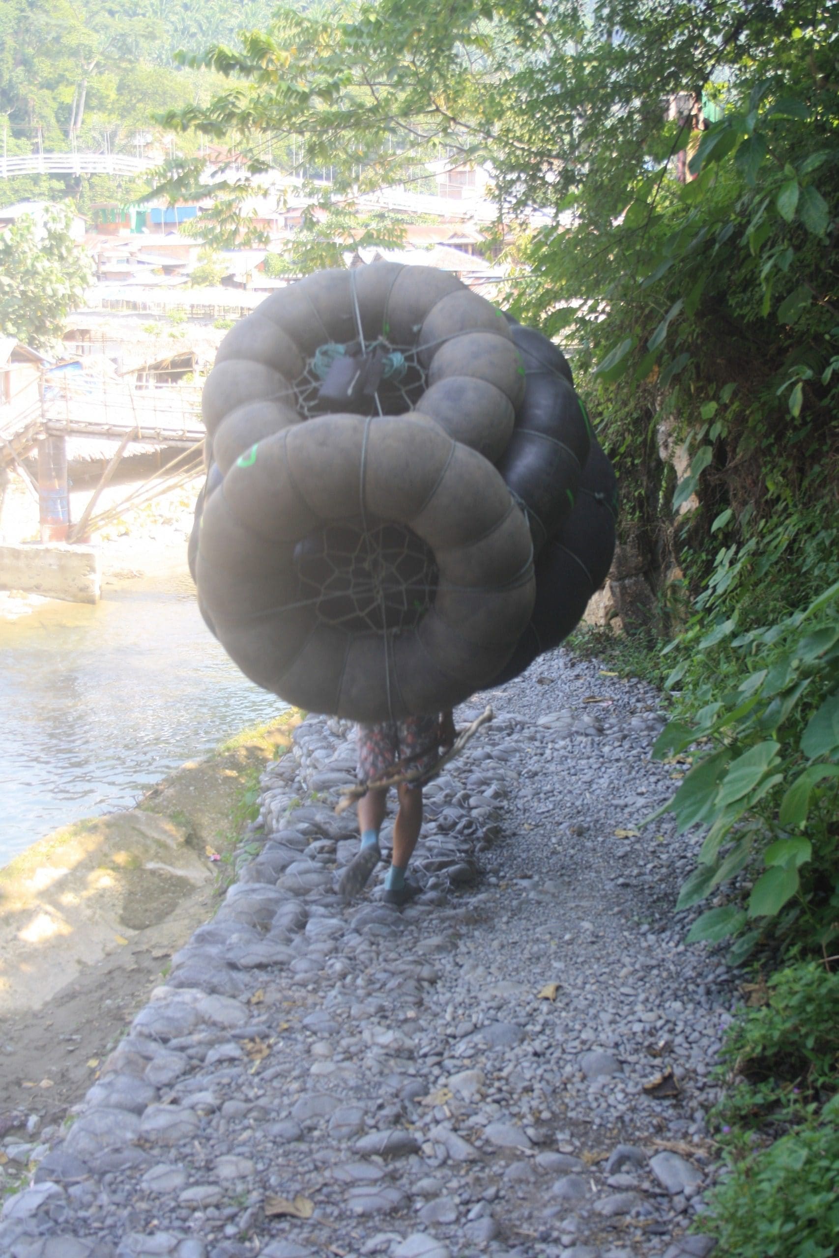 men carry the tubes for trekkers, Bukit Lawang