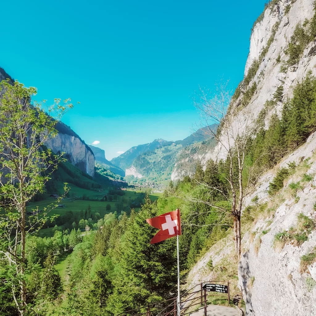 Swiss flag flying over the valley from the waterfalls