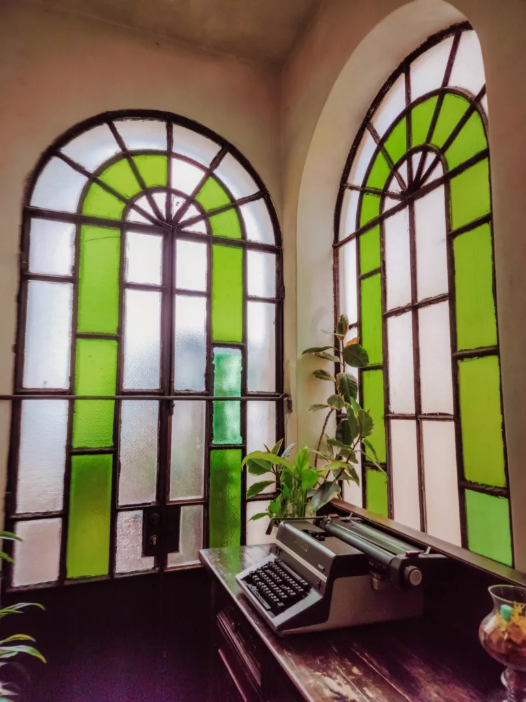 Green and white stained glass windows in the lobby of historic hotel Villa Mabel in Taormina, Sicily, Italy