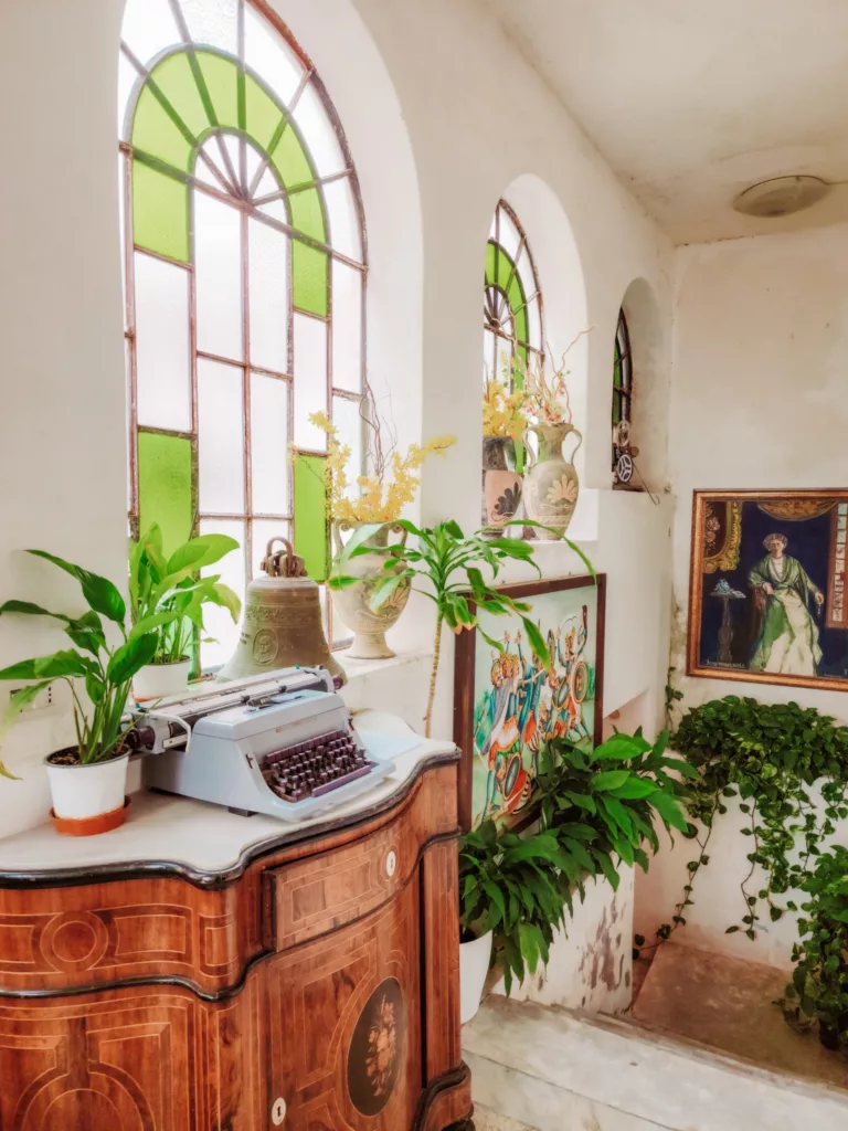 old typewriter and stained glass windows in the lobby of historic hotel Villa Mabel in Taormina, Sicily, Italy
