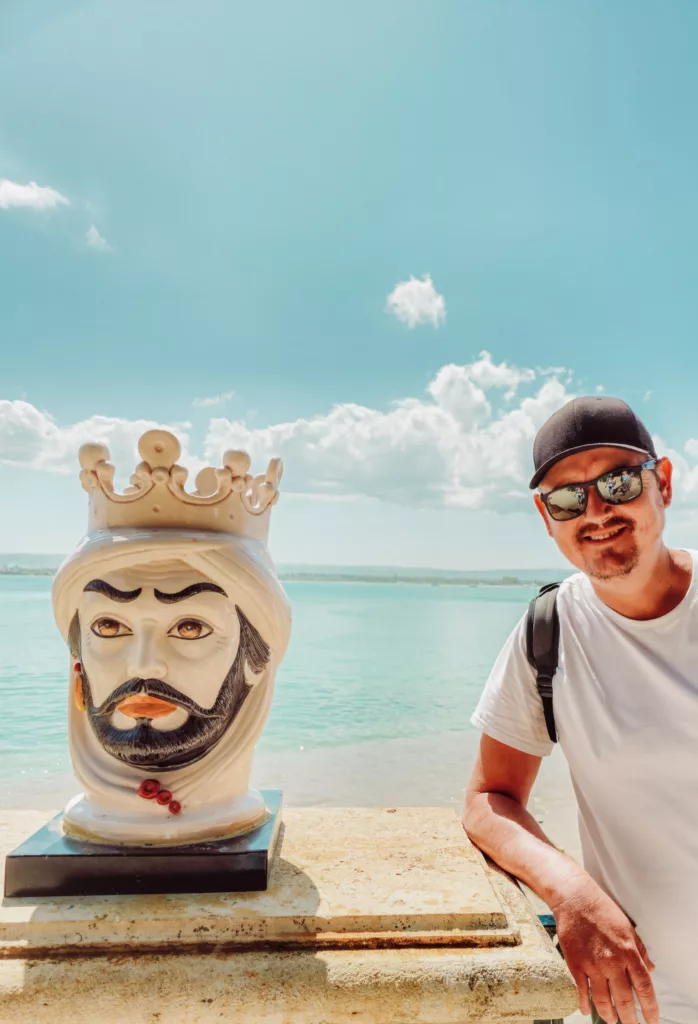 Sicilian head statues at the beach off the Lungamore Ortigia Sicily