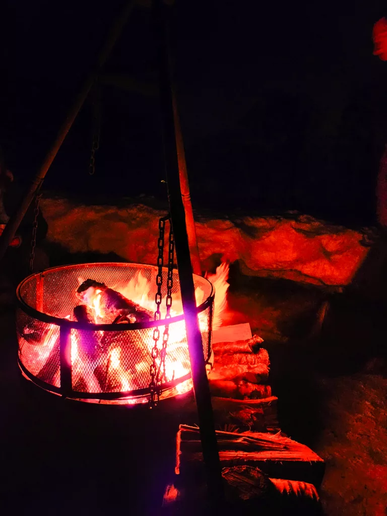 camp fire in the snow ready to watch for the northern lights on our Best Arctic tour Tromso
